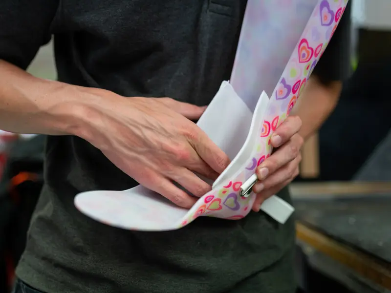 Hands fitting a white insole into a custom foot and ankle brace